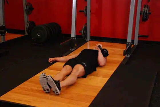 One-Arm Kettlebell Floor Press — start position