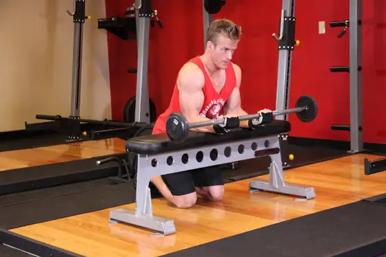 Palms-Up Barbell Wrist Curl Over A Bench — end position