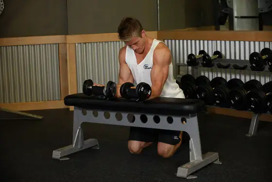 Palms-Up Dumbbell Wrist Curl Over A Bench — end position