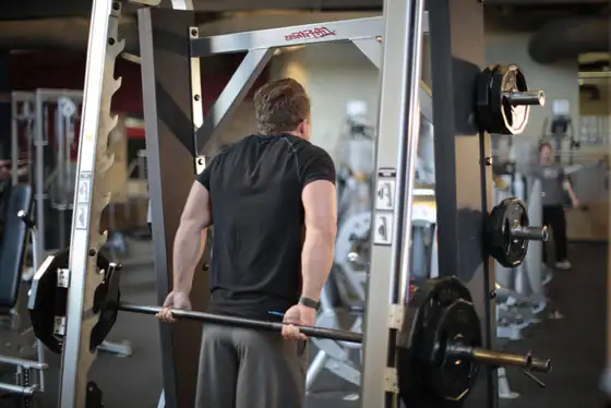Smith Machine Behind the Back Shrug — end position